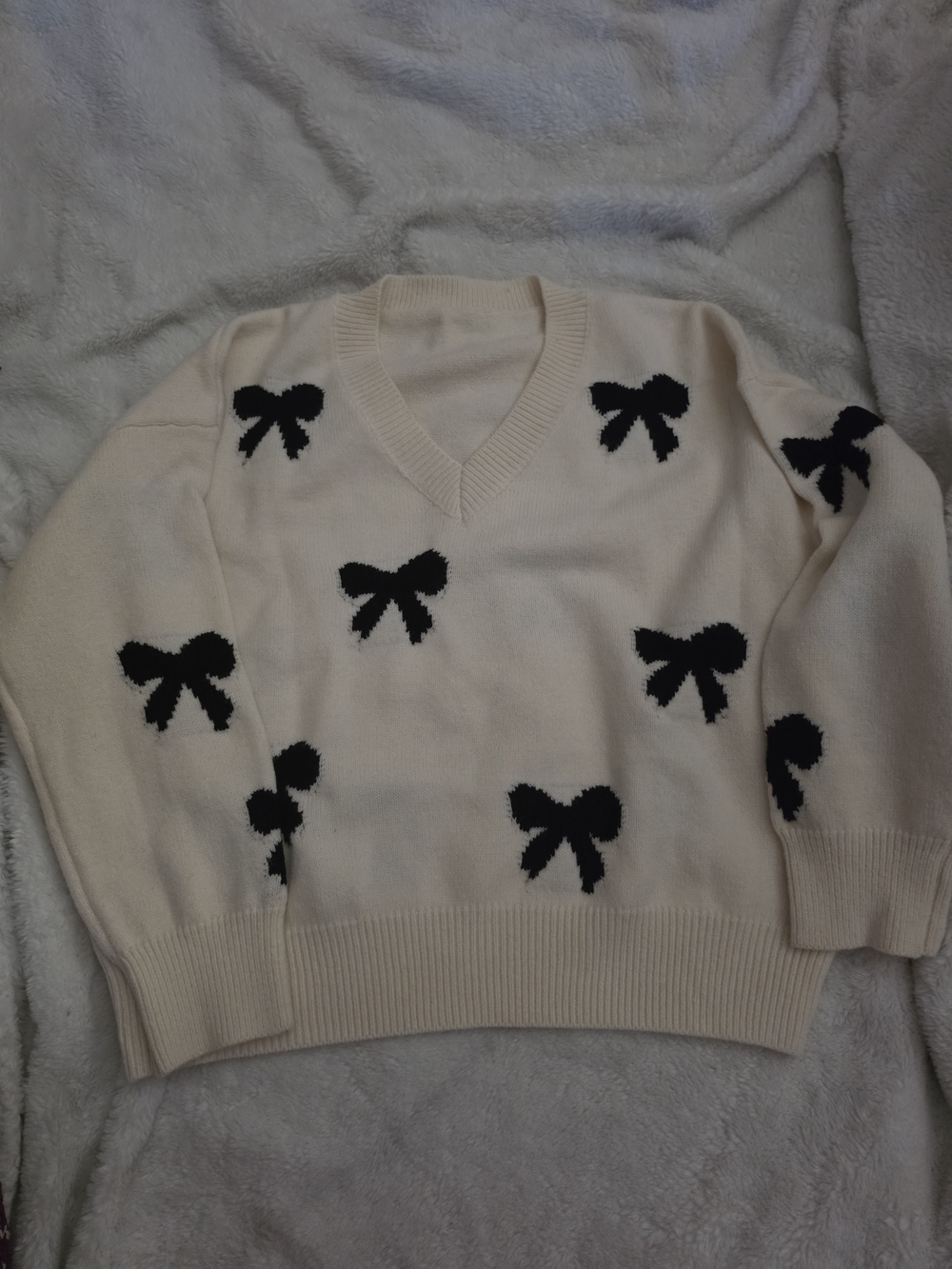 V-Neck Cream Sweater with Black Bow Motif